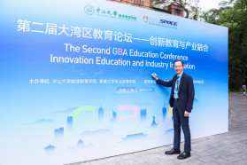 Professor William K.M. Lee, Director, signing the backdrop